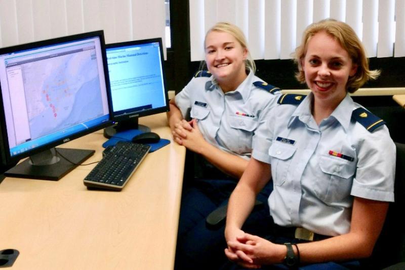 Female Coast Guard cadets at dual monitor system.