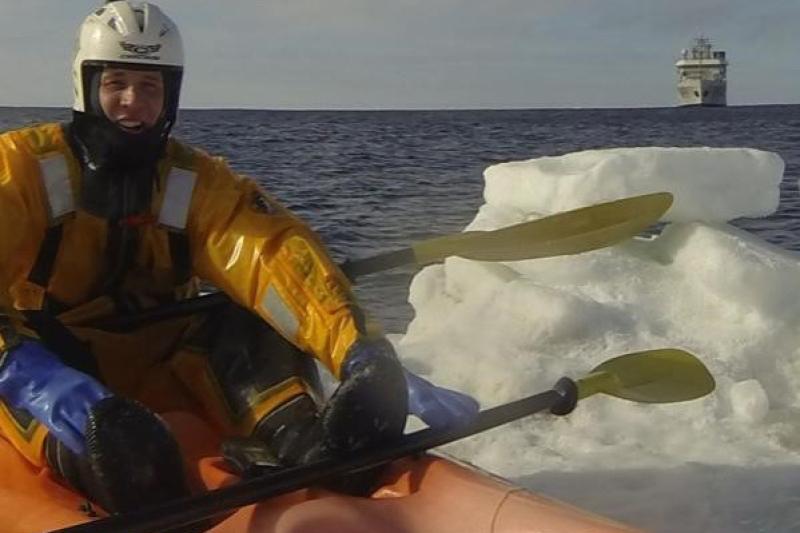 Benjamin VanDine kayaking in icy waters.