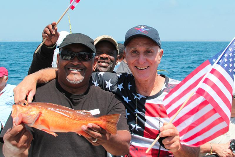 larry brown celebrates a successful catch with veterans aboard the Betty O.jpg