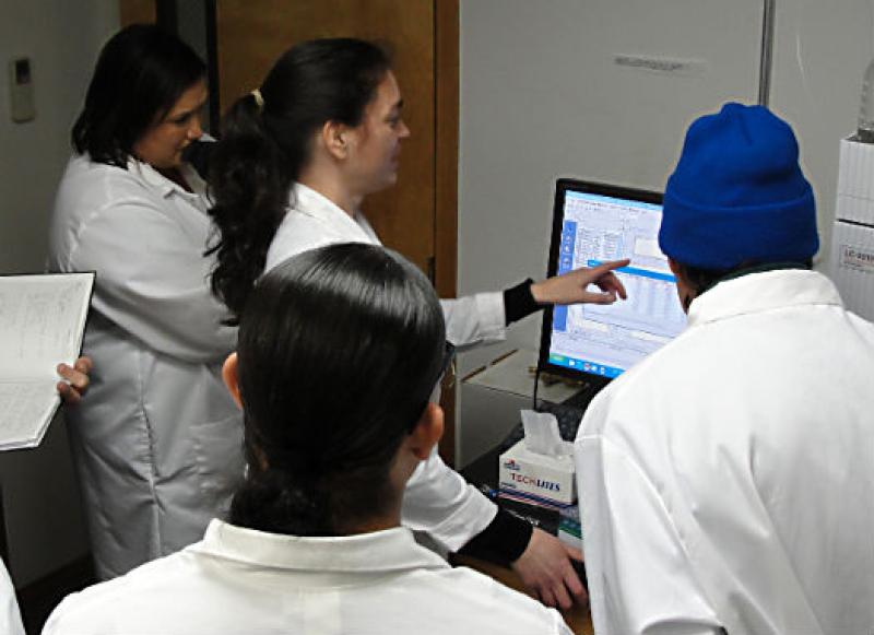 Dr. Frame explains how the HPLC apparatus detects domoic acid in fish and shellfish. Photo: NOAA Fisheries