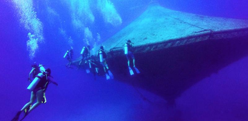divers around the open-ocean aquaculture cage at the Cape Eleuthera Institute at Cape Eleuthera in the Bahamas.