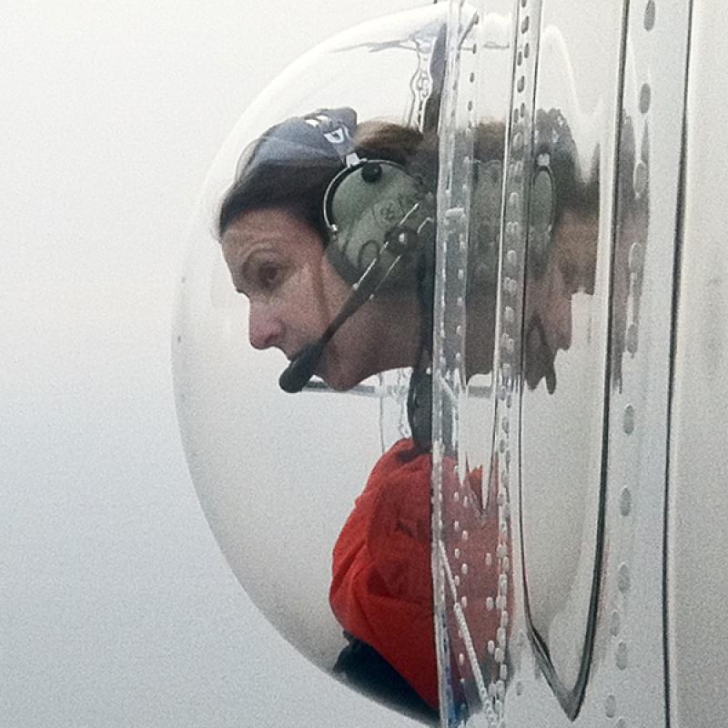 Christin Khan in observation bubble with headset.