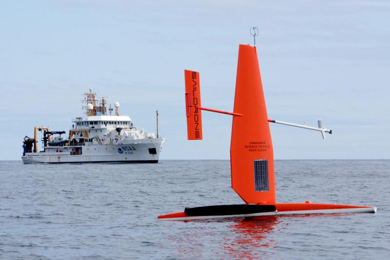 Sail drone at sea with ship in background